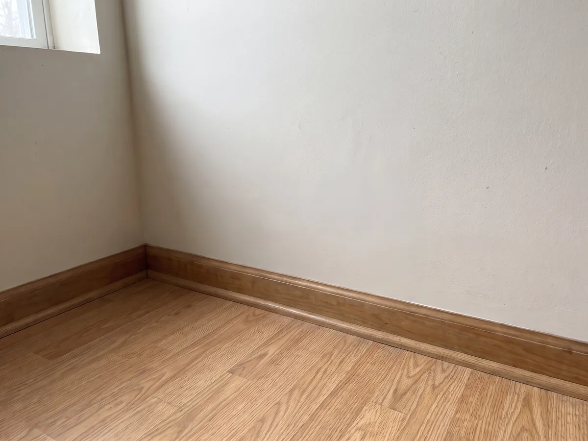 After mold remediation in Gettysburg, PA: the same basement wall with new drywall, fresh paint and a new baseboard